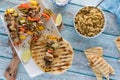 Grilled chicken and veggie shish kebabs, served with rice pilaf and naan bread. Royalty Free Stock Photo