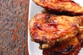 Grilled chicken in white plate put on wooden table