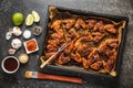 Grilled chicken wings in barbecue sauce in baking tray