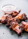 Chicken wings with bbq sauce on a black plate Royalty Free Stock Photo