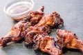 Chicken wings with bbq sauce on a black plate Royalty Free Stock Photo
