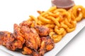 Grilled chicken wings with french fries an tomato sauce on white plate Royalty Free Stock Photo