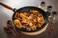 Grilled chicken wings in grill panwith spices, wooden background