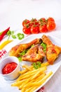 Grilled chicken wings,legs,chips and vegetables Royalty Free Stock Photo