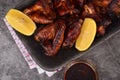 Grilled chicken wings on a plate with lemon and sauce Royalty Free Stock Photo