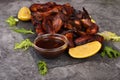 Grilled chicken wings on a plate with lemon and sauce Royalty Free Stock Photo