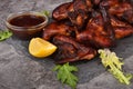 Grilled chicken wings on a plate with lemon and sauce Royalty Free Stock Photo