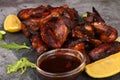 Grilled chicken wings on a plate with lemon and sauce Royalty Free Stock Photo