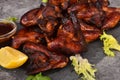 Grilled chicken wings on a plate with lemon and sauce Royalty Free Stock Photo