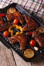 Grilled chicken wings with vegetables in a grill pan close-up. Royalty Free Stock Photo