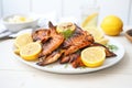 grilled chicken wings on a white plate, with lemon slices Royalty Free Stock Photo