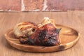 grilled chiken on wooden plate