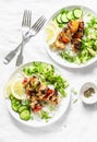 Grilled chili honey lime chicken skewers with rice and avocado salsa on light background, top view Royalty Free Stock Photo