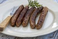 Grilled chipolata sausages on a plate