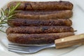 Grilled chipolata sausages on a plate