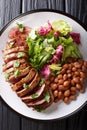 Grilled chopped beef steak with fresh salad and beans close-up. Royalty Free Stock Photo