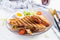 Grilled club sandwich panini with ham, tomato, cheese, avocado and cup of coffee. Royalty Free Stock Photo