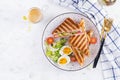 Grilled club sandwich panini with ham, tomato, cheese, avocado and cup of coffee. Royalty Free Stock Photo