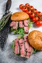 Grilled cold cuts roast beef burger sandwich with arugula and spinach. White background. Top view Royalty Free Stock Photo
