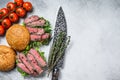 Grilled cold cuts roast beef burger sandwich with arugula and spinach. White background. Top view. Copy space Royalty Free Stock Photo