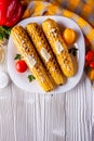 Grilled corn cob on white wooden rustic background Royalty Free Stock Photo