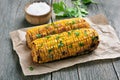 Grilled corn cobs on rustic table Royalty Free Stock Photo