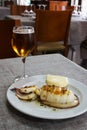 Grilled cuttlefish with sauce on a white plate. Delicious wholesome dinner at a Spanish fish restaurant. Royalty Free Stock Photo