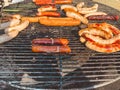 Grilled dishes. juicy and hearty sausages on the grill for cooking meat and steaks. appetizing meat dish. food festival in city Royalty Free Stock Photo