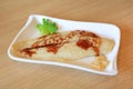 Grilled Dolly fish steak served on white plate on wood table background. Royalty Free Stock Photo