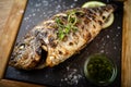 Grilled dorada fish with lemon and spinach Royalty Free Stock Photo