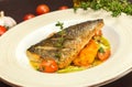 Grilled dorado fish with fried potatoes, lemon and tomato Royalty Free Stock Photo