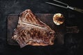 Grilled Dry Aged T-bone Steak on Rustic Chopping Board. USDA Prime Beef. Royalty Free Stock Photo