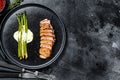 Grilled duck breast steak with baked asparagus. Black background. Top view. Copy space Royalty Free Stock Photo