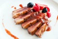 Grilled duck breast with sweet red fruit dressing.
