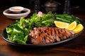 grilled duck and fresh greens on a plate