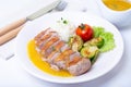 Grilled duck with mashed cauliflower, fried brussels sprouts and orange sauce on a white plate. Royalty Free Stock Photo