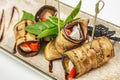 Grilled eggplant rolls stuffed with cheese and red peppers on a ceramic plate. top view Royalty Free Stock Photo
