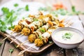 grilled falafel kebabs and tahini sauce on a tray