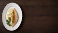 Grilled Fish Fillet With Lemon on a White Plate, Copy Space