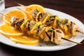 grilled fish skewer covered in a tangy orange glaze