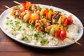 grilled fish skewers served on top of a bed of rice Royalty Free Stock Photo