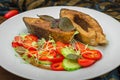 Grilled fish steak with vegetables on plate: tomatoes, microgran, cucumber, tasty and healthy dinner. Wooden rustic background. To Royalty Free Stock Photo