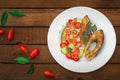 Grilled fish steak with vegetables on plate: tomatoes, microgran, cucumber, tasty and healthy dinner. Wooden rustic background. To Royalty Free Stock Photo