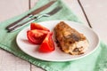 Grilled fish with tomato on a plate, fork and knife Royalty Free Stock Photo
