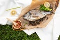 Grilled fish on wooden board with salad and lemon Royalty Free Stock Photo