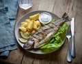 Grilled fish on wooden kitchen table Royalty Free Stock Photo