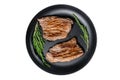 Grilled flat iron and flank steaks in a pan. Marble beef meat. Isolated, white background.