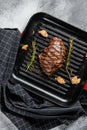 Grilled Flat Iron steak on a grill pan, marbled beef. Gray background. Top view