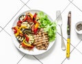 Grilled flounder fillet and roasted vegetables on a light background, top view. Delicious healthy diet food