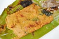 Grilled flower crab with curry paste in banana leaf on plate